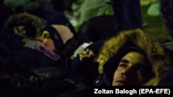 A group of migrants rest in the Serbian village of Kelebia, bordering Hungary, on February 7.