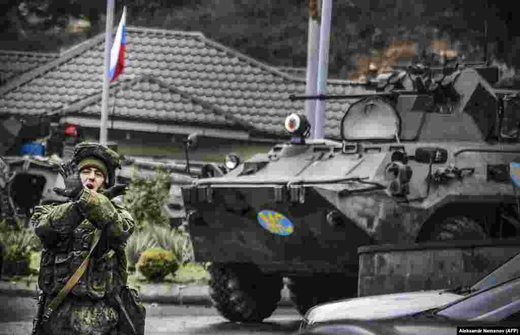 A Russian peacekeeper shouts &quot;No pictures!&quot; at a checkpoint outside the city of Stepanakert on November 13. Russia began deploying 2,000 peacekeepers to the breakaway region of Nagorno-Karabakh on November 10 after Armenia and Azerbaijan agreed to a peace deal to end weeks of fierce fighting. (AFP/Alexander Nemenov)