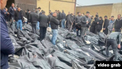 A video grab taken on January 14 from UGC images posted on social media on January 13 shows dozens of bodies lying outside the Tehran Province Forensic Diagnostic and Laboratory Center in Kahrizak, as grieving relatives search for their loved ones.