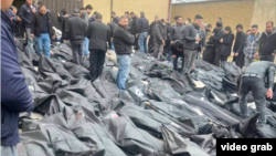 Grieving relatives searching for their loved ones among piles of bodies outside the Tehran Province Forensic Diagnostic and Laboratory Center in Kahrizak, Iran, are shown in UGC images posted on social media on January 13.