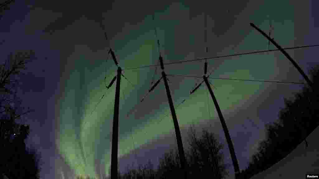 Aurora borealis lights dance over power lines at mile 9 on the Old Glenn Highway near Butte, Alaska. (Reuters/Oscar Edwin Avellaneda)