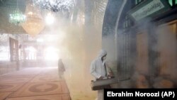 A firefighter disinfects the shrine of Saint Saleh to help prevent the spread of the new coronavirus in northern Tehran, Iran, Friday, March 6, 2020.