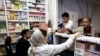 Iranians buy medicines at a pharmacy in Tehran in April. The Iranian Pharmacists Association says around 800 medicines are currently on the country's shortage list. 