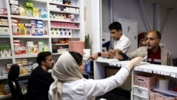 Iranians buy medicines at a pharmacy in Tehran in April. The Iranian Pharmacists Association says around 800 medicines are currently on the country's shortage list. 