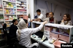 Iranians try to fill their prescriptions at a pharmacy in Tehran.