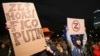 A woman with a poster reading "Bad, worst, Fico, Putin" at a pro-Ukrainian rally in Bratislava on March 12. 