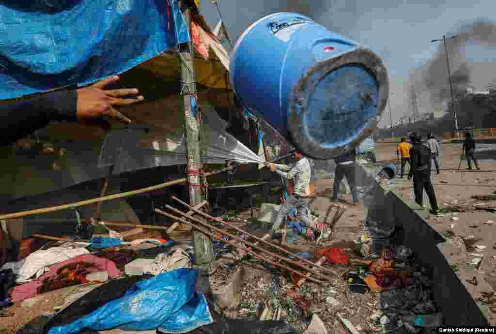 People supporting a new Indian citizenship law destroy a protest site used by those opposing the law in New Delhi. (Reuters/Danish Siddiqui)