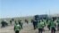 Videos and photos that circulated on social media showed hundreds of workers in hard hats and uniforms massing at a site near the Tengiz oil field. 