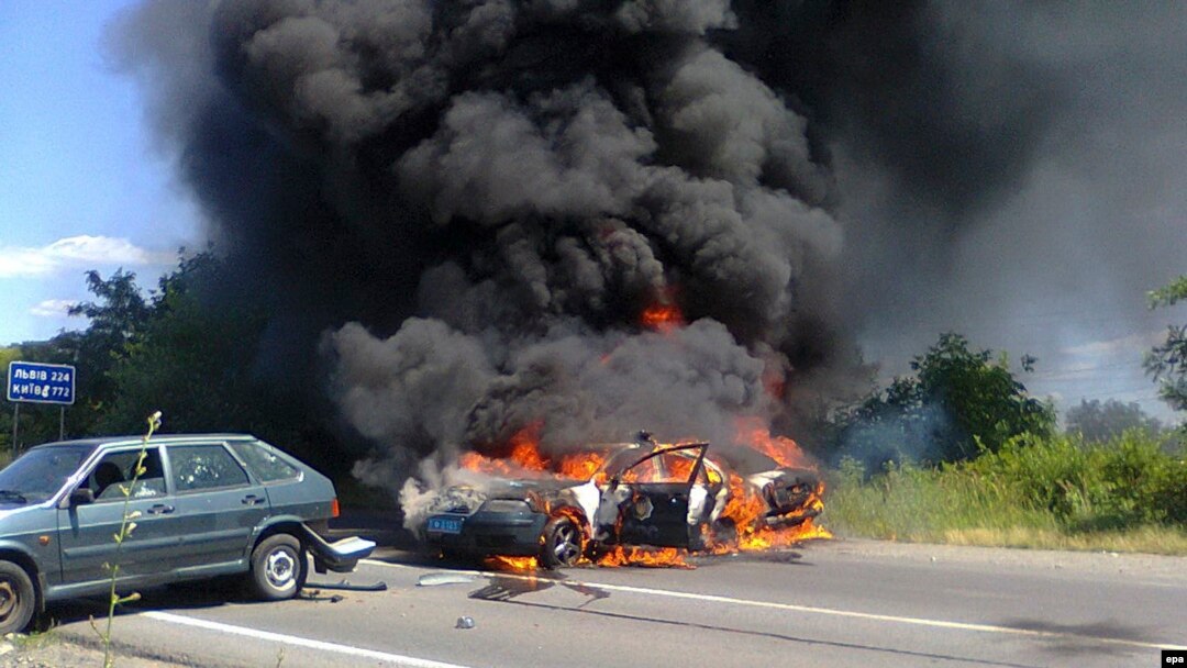 A burning police car is seen following a gunbattle in the western city of Mukacheve on July 11 between Right Sector and security forces.