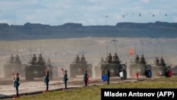 Russian, Chinese, and Mongolian troops and military equipment parade at the end of the day of the Vostok-2018 military drills not far from the Chinese-Mongolian border in Siberia in September 2018.