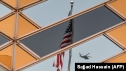 The U.S. flag and a helicopter are reflected in the windows of the U.S. Embassy in Kabul. (file photo)