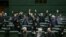 IRAN -- Iranian lawmakers rais their hands to vote during a parliamentary session in Tehran, January 7, 2020