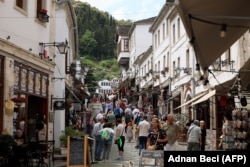 Local residents and tourists walk along a street of Gjirokastra, a UNESCO World Heritage site in southern Albania, on May 7, 2025, ahead of Albania's general election on May 11. Albanians go to the polls on May 11, 2025 for legislative elections seen as crucial to gauge the country's democratic development and determine its widely held goal of a European future. (Photo by Adnan Beci / AFP)
