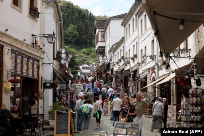 Local residents and tourists walk along a street of Gjirokastra, a UNESCO World Heritage site in southern Albania, on May 7, 2025, ahead of Albania's general election on May 11. Albanians go to the polls on May 11, 2025 for legislative elections seen as crucial to gauge the country's democratic development and determine its widely held goal of a European future. (Photo by Adnan Beci / AFP)
