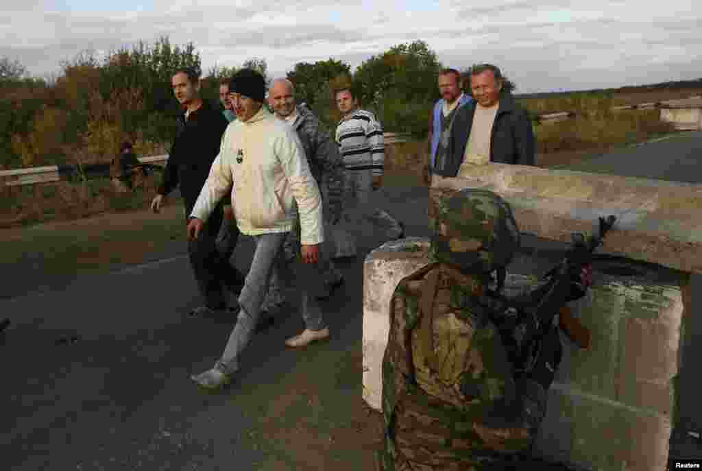 Звільнені з полону українські військовослужбовці проходять повз український блокпост біля Луганська, 22 вересня 2014 року