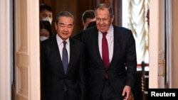 China's top foreign policy official, Wang Yi (left), and Russian Foreign Minister Sergei Lavrov meet in Moscow on February 22.
