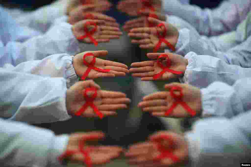 Students hold red ribbons during an event to mark World AIDS Day on December 1 at a medical college in Yangzhou, Jiangsu Province, China. (Reuters/Stringer)