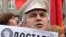 Russia -- The day of people's anger (rage) in Moscow, meeting. A man hold newspaper with "Had have enough" (being got at) title, protest, 25Oct2008