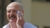 Belarusian President Alyaksandr Lukashenka wipes his face as he addresses supporters on Independent Square in Minsk on August 16.