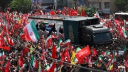 A truck carrying the coffins of Iran's late Supreme Leader Ayatollah Ali Khamenei and family members killed in an air strike in February makes its way through the streets of Tehran on July 6. 