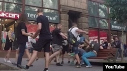 A video experiment in which a gay couple strolled around Kyiv hand-in-hand to gauge homophobic sentiment went largely without incident until they were attacked by a group of men. 