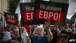 Muškarac drži transparent na kojem na bugarskom jeziku piše "Ne želimo euro" tokom demonstracija protiv ulaska Bugarske u eurozonu u Sofiji 4. juna 2025.