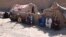 AFGHANISTAN -- An internally displaced Afghan family outside a temporary shelter as they wait for relief from the authorities due to the summer season, on the outskirts of Herat, June 15, 2021
