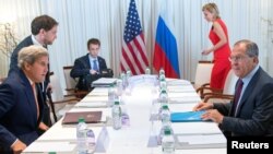 U.S. Secretary of State John Kerry (front left) and Russian Foreign Minister Sergei Lavrov (front right) sit down for bilateral talks focused on the Syrian crisis in Geneva on August 26.