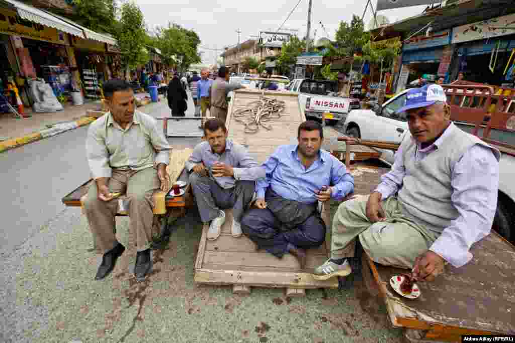 Traders drink tea in a market in Irbil.