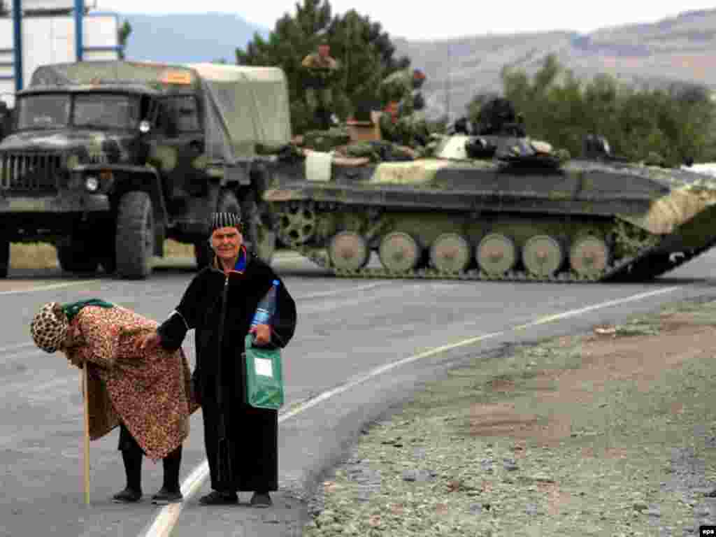 Russia-Georgia war - A Georgian elderly couple who fled from the village of Korta and walked for four days are pictured outside the Georgian town of Gori, Georgia, on 15 August 2008. Russian troops on 15 August allowed some humanitarian supplies into the city of Gori but continued their blockade of the strategically located city, raising doubts about Russia's intentions in the war-battered country. 