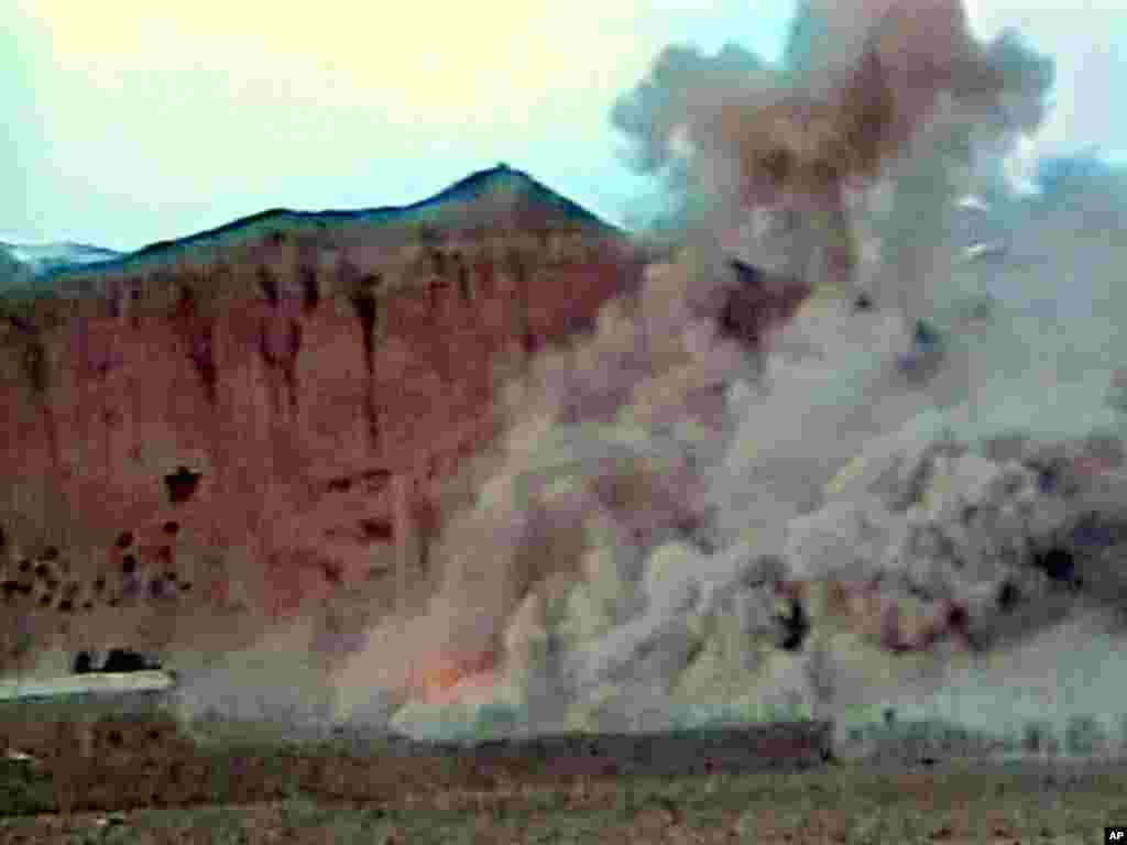 An explosion rips apart one of the Buddhas in March 2001.