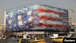 A billboard on Tehran's Enqelab Square depicts Iranian missiles striking a US aircraft carrier on January 26.