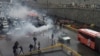 Riot police tries to disperse people as they protest on a highway against increased gas price in Tehran, Iran November 16, 2019.