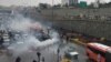 Riot police triy to disperse people as they protest on a highway against increased gas price in Tehran, Iran November 16, 2019.