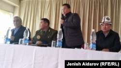 Kamchybek Tashiev (second from left), the chief of Kyrgyzstan’s State Committee for National Security, meets with villagers from Ak-Sai on February 18.