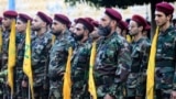 Hezbollah fighters take part in a funeral procession on September 25.