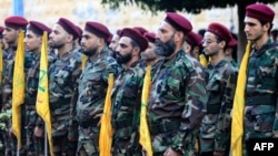 Hezbollah fighters take part in a funeral procession on September 25.