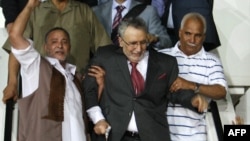 Lockerbie bomber Abdel Basset al-Megrahi (center), the sole Libyan convicted over the 1988 Pan Am jetliner bombing, was greeted as a hero upon his arrival in Tripoli in August 2009.