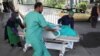 A wounded woman arrives for treatment at a hospital after a blast in Kabul on July 25. 