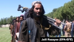 Former Taliban militants surrendering their weapons during a reconciliation ceremony in Herat, Afghanistan on June 24