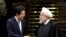 Japanese Prime Minister Shinzo Abe, left, and Iranian President Hassan Rouhani shake hands after their joint press conference on June 12, 2019. 