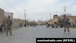 U.S. troops cordon off the site of a bomb blast in Kandahar.