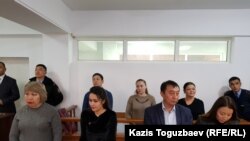 Three of the activists (back row, left to right) Anuar Ashiraliev, Oksana Shevchuk, and Gulzipa Zhaukerova in court on November 19. 