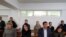 Three of the activists (back row, left to right) Anuar Ashiraliev, Oksana Shevchuk, and Gulzipa Zhaukerova in court on November 19. 