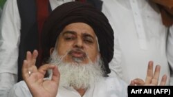 FILE: Khadim Hussain Rizvi, ultra-religious Tehreek-e-Labaik Pakistan (TLP) party, gestures as he speaks to media in Lahore in July.