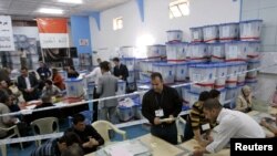 Officials audit suspect ballots at a counting center in Kirkuk on March 18.