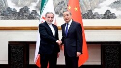 Chinese Foreign Minister Wang Yi (right) meets his Iranian counterpart, Abbas Araqchi, in Beijing on May 9. 