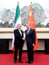Chinese Foreign Minister Wang Yi (right) meets his Iranian counterpart, Abbas Araqchi, in Beijing on May 9. 
