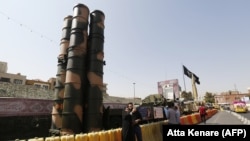 People take a picture next to a Russian-made S-300 air defense system displayed on Baharestan square in Tehran, September 24, 2017