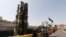 People take a picture next to a Russian-made S-300 air defense system displayed on Baharestan square in Tehran, September 24, 2017